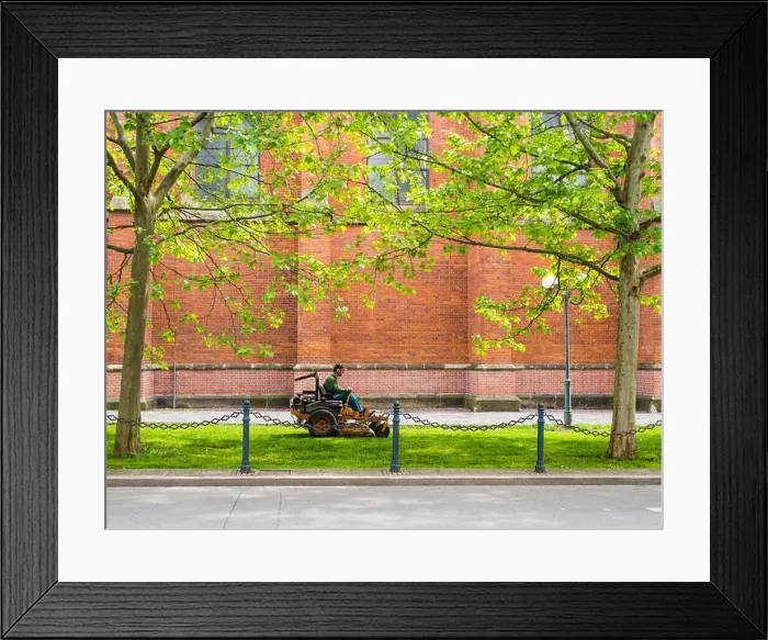 Framed Print : Public servise: Man on a mower cutting grass in the city Framed Print : Public servise: Man on a mower cutting grass in the city