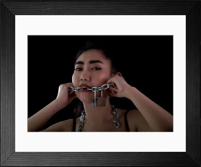 Framed Print : Portrait young Asia woman covered mouth by a steel chain Framed Print : Portrait young Asia woman covered mouth by a steel chain