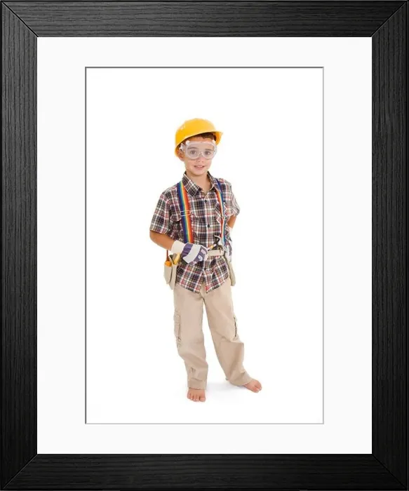 Framed Print : Young caucasian boy dressed in a carpenter outfit standing on a white background Framed Print : Young caucasian boy dressed in a carpenter outfit standing on a white background