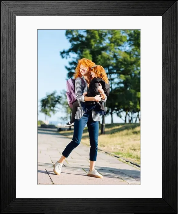 Framed Print : Charming red haired female holding her child Framed Print : Charming red haired female holding her child