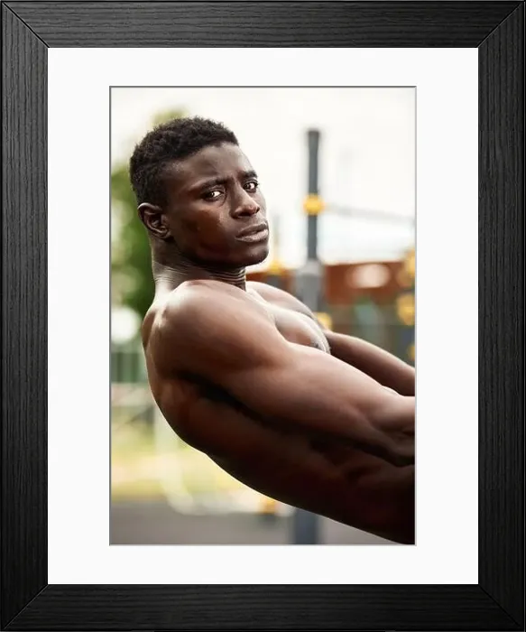 Framed Print : Handsome afro American sportman sitting on the street while taking break after training Framed Print : Handsome afro American sportman sitting on the street while taking break after training