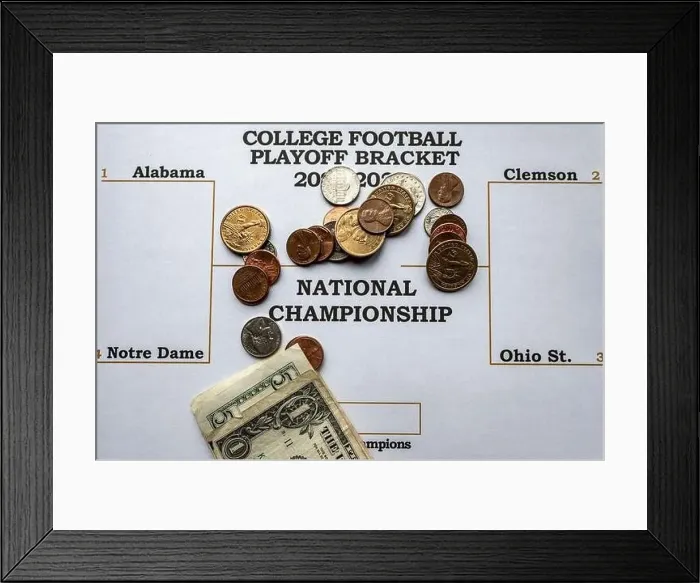 Framed Print : Filling out a sports bracket and betting money on the winner Framed Print : Filling out a sports bracket and betting money on the winner