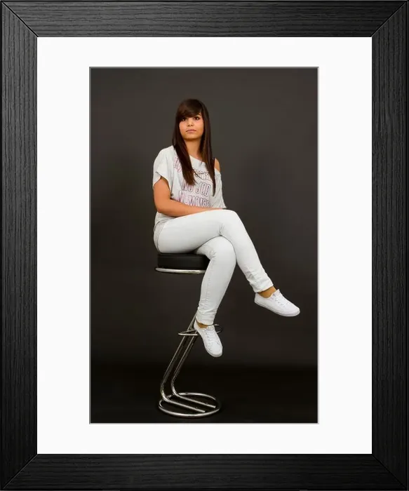 Framed Print : Teenager with long dark hair and brown eyes sitting on a bar stool Framed Print : Teenager with long dark hair and brown eyes sitting on a bar stool
