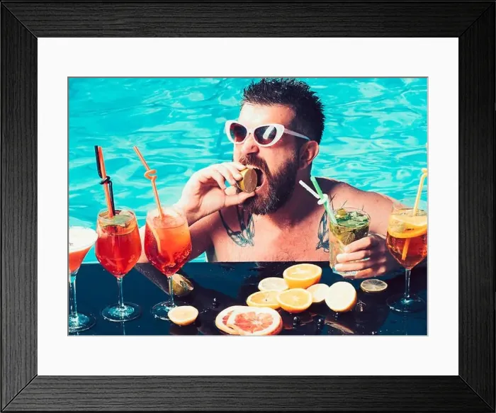 Framed Print : Cocktail with fruit at bearded man in pool Framed Print : Cocktail with fruit at bearded man in pool