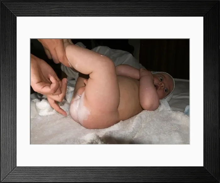 Framed Print : changing nappies of a 6 month old baby Framed Print : changing nappies of a 6 month old baby