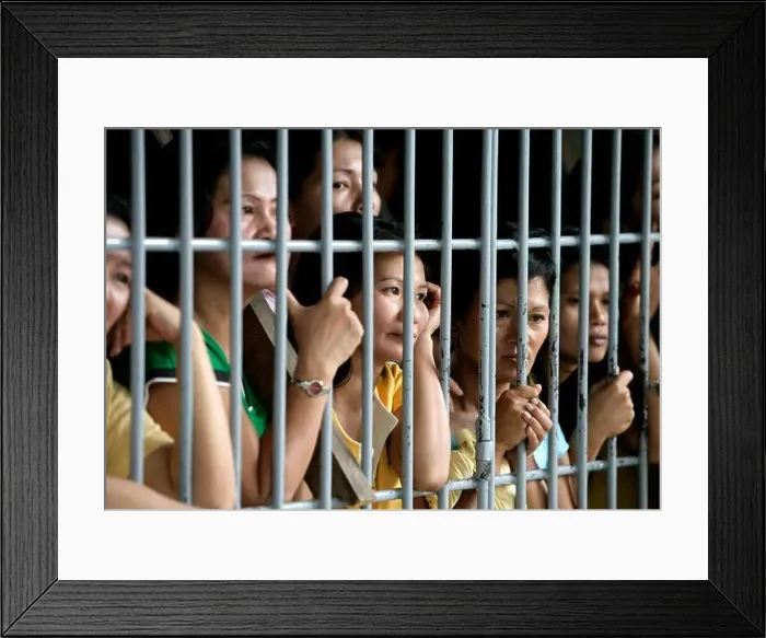 Framed Print : Convicted women behind bars in a communal cell in the Angeles District Jail, The Phillipines Framed Print : Convicted women behind bars in a communal cell in the Angeles District Jail, The Phillipines