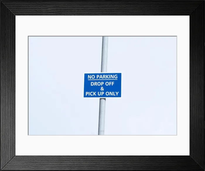 Framed Print : No parking drop off and pick up only sign post in sky at airport Framed Print : No parking drop off and pick up only sign post in sky at airport