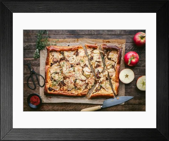 Framed Print : Puff Pastry tart with cheese, sliced apples and thyme on parchment with knife and fresh apples Framed Print : Puff Pastry tart with cheese, sliced apples and thyme on parchment with knife and fresh apples
