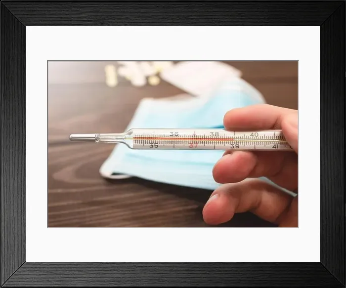 Framed Print : A medical clinical mercury thermometer in person's hand showing the temperature of 39 C Framed Print : A medical clinical mercury thermometer in person's hand showing the temperature of 39 C