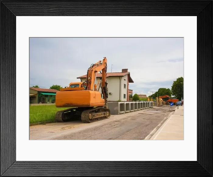 Framed Print : A crawler excavator with rotating house platform & continuous caterpillar track with reinforced concrete box culverts Framed Print : A crawler excavator with rotating house platform & continuous caterpillar track with reinforced concrete box culverts