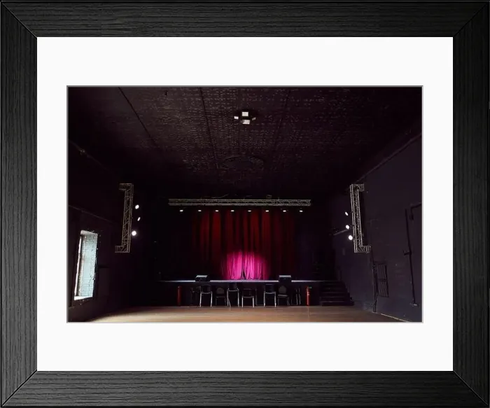Framed Print : Interior of empty concert hall without chairs and small stage with purple curtains