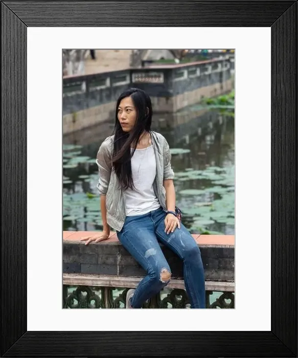 Framed Print : Portrait of beautiful Asian girl hanging out in a Japanese garden pond with some traditional architecture in Framed Print : Portrait of beautiful Asian girl hanging out in a Japanese garden pond with some traditional architecture in