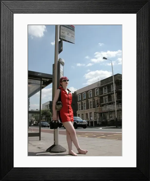 Framed Print : girl in short sexy red dress at London bus stop
