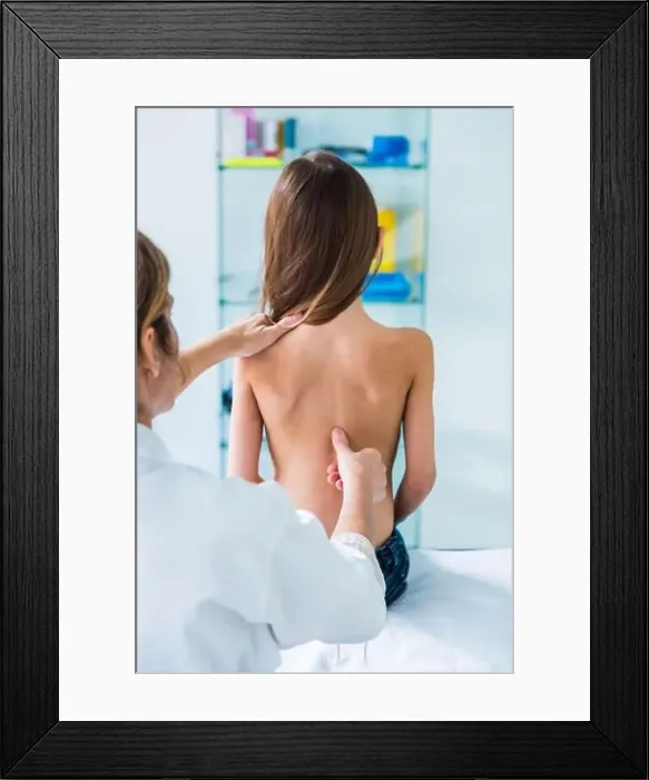 Framed Print : Doctor examining back of 7 year old girl Framed Print : Doctor examining back of 7 year old girl