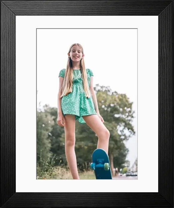 Framed Print : Smiling blond girl with skateboard in park Framed Print : Smiling blond girl with skateboard in park
