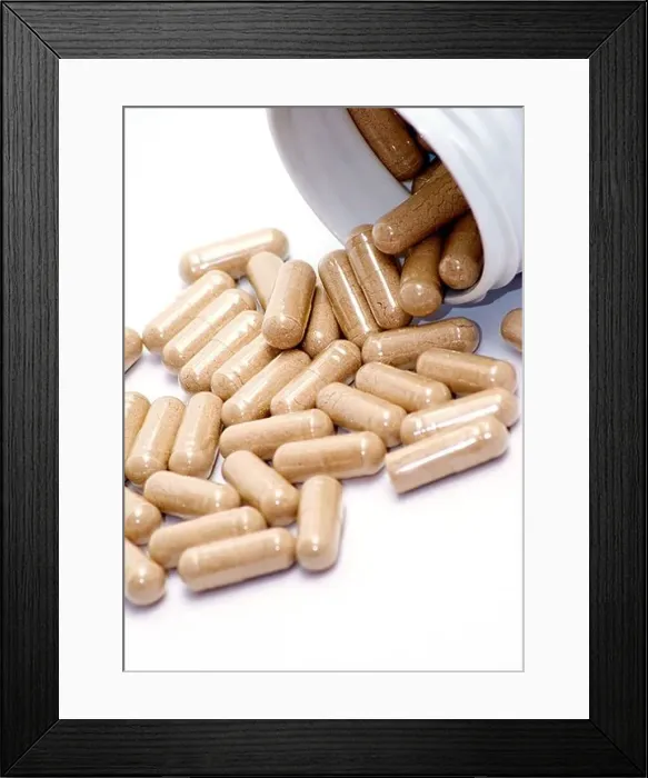 Framed Print : Closeup image of brown pills - roughage on the white background Framed Print : Closeup image of brown pills - roughage on the white background