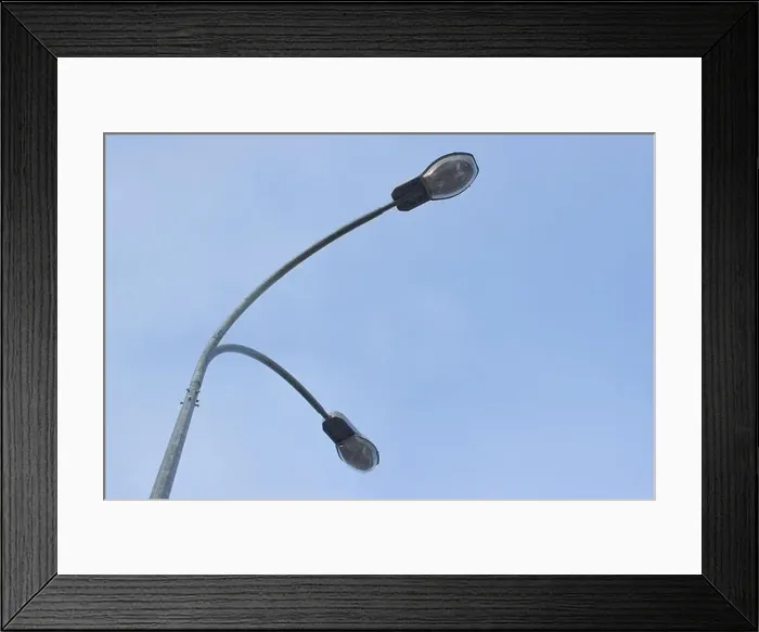 Framed Print : Street light with halogen lamp against blue sky Framed Print : Street light with halogen lamp against blue sky
