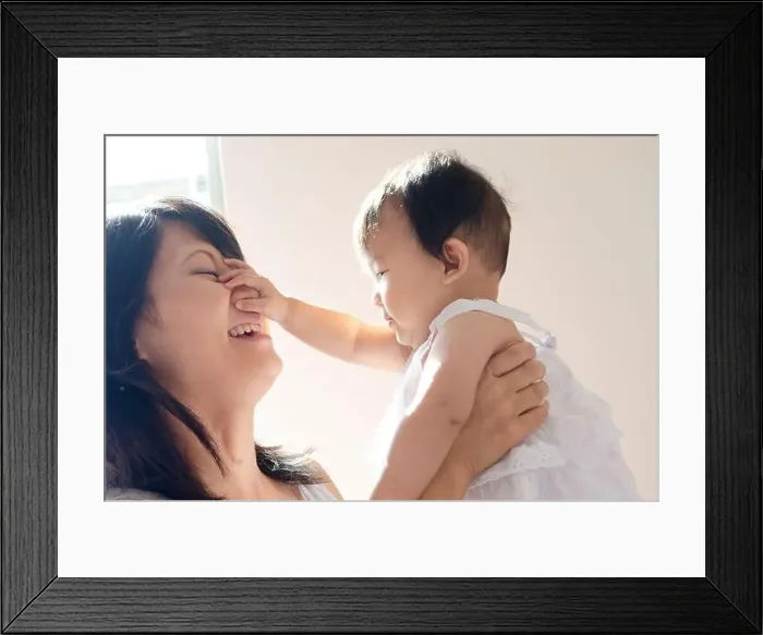 Framed Print : Baby touching mother's face Framed Print : Baby touching mother's face