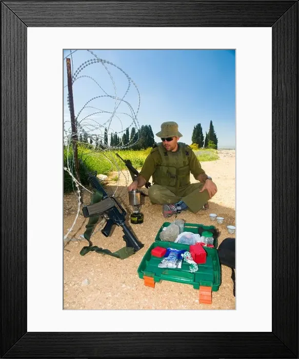 Framed Print : Israel West Bank Israeli reserve soldier preparing coffee at leisure during active duty Framed Print : Israel West Bank Israeli reserve soldier preparing coffee at leisure during active duty
