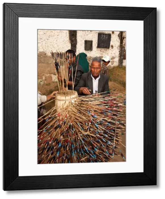 Framed Print : India, Meghalaya, Shillong, Bola archery gambling game, officials counting number of arrows in target