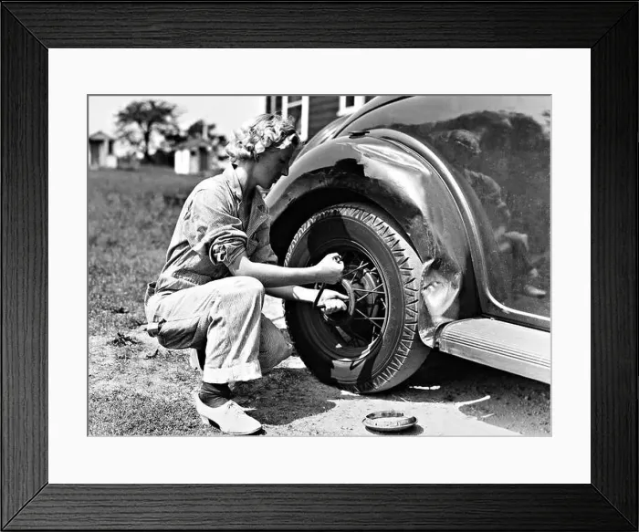 Framed Print : Woman changing a tire, 1937 Framed Print : Woman changing a tire, 1937