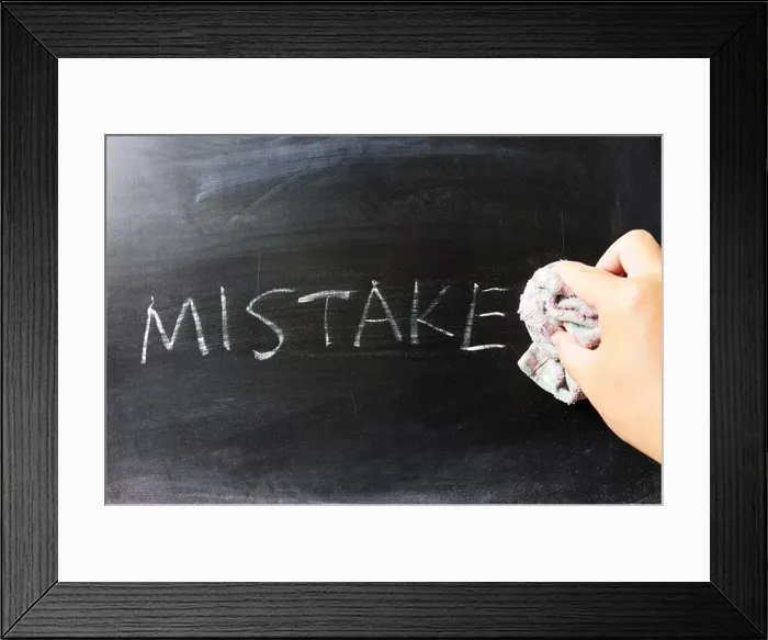 Framed Print : Hand wiping off mistake word using rag Framed Print : Hand wiping off mistake word using rag