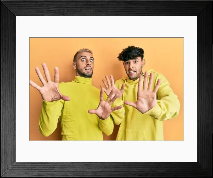 Framed Print : Homosexual gay couple standing together wearing yellow clothes afraid Framed Print : Homosexual gay couple standing together wearing yellow clothes afraid