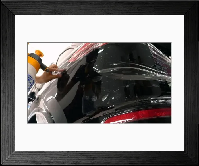 Framed Print : Close up to PPF installation process on a front headlight and hood Framed Print : Close up to PPF installation process on a front headlight and hood