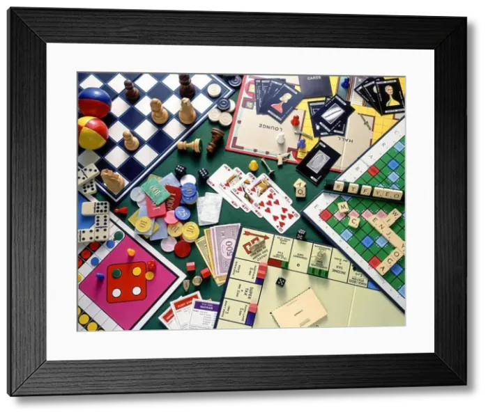 Framed Print : Still-life selection of board games (Monopoly, Chess, Cluedo, Scrabble) with playing cards and gambling chips Framed Print : Still-life selection of board games (Monopoly, Chess, Cluedo, Scrabble) with playing cards and gambling chips