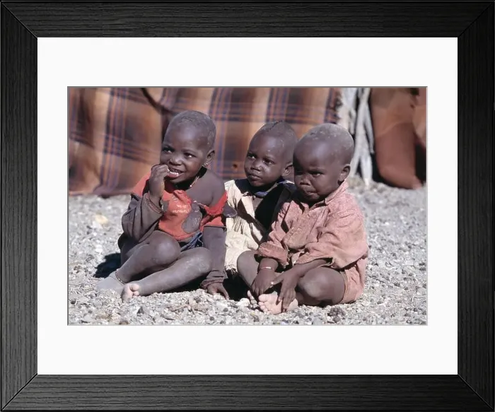 Framed Print : Namibia. Himba tribe village. Children sitting outside Framed Print : Namibia. Himba tribe village. Children sitting outside