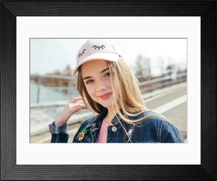Framed Print : Portrait closeup beautiful young girl in pink hat in city street Framed Print : Portrait closeup beautiful young girl in pink hat in city street