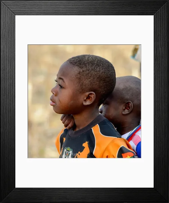 Framed Print : KOUTAMMAKOU, TOGO - JAN 13, 2017: Unidentified Togolese little boy carries his brother on his back in the village Framed Print : KOUTAMMAKOU, TOGO - JAN 13, 2017: Unidentified Togolese little boy carries his brother on his back in the village