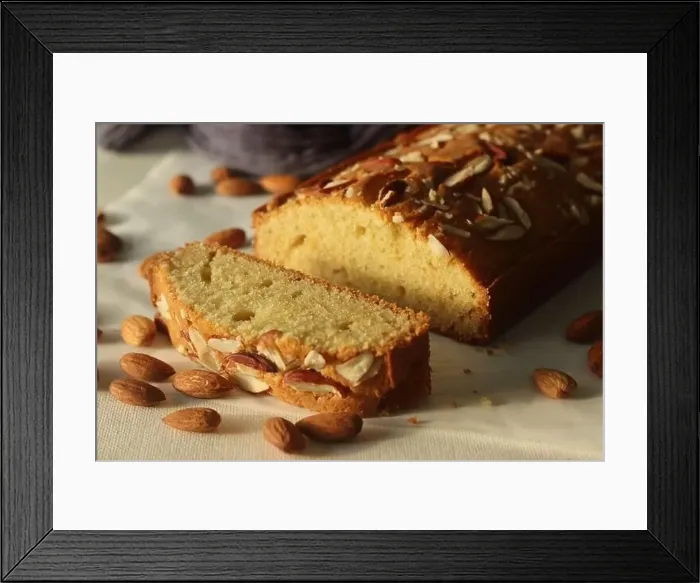 Framed Print : Ghee cake slice. Vanilla flavoured ghee cake with almonds on top Framed Print : Ghee cake slice. Vanilla flavoured ghee cake with almonds on top