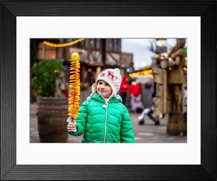 Framed Print : Little girl holding Tornado potatoes, also called twist potatoes or tornado fries Framed Print : Little girl holding Tornado potatoes, also called twist potatoes or tornado fries