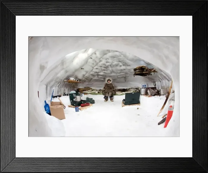 Framed Print : A young inuit sits on a bed in an igloo Framed Print : A young inuit sits on a bed in an igloo