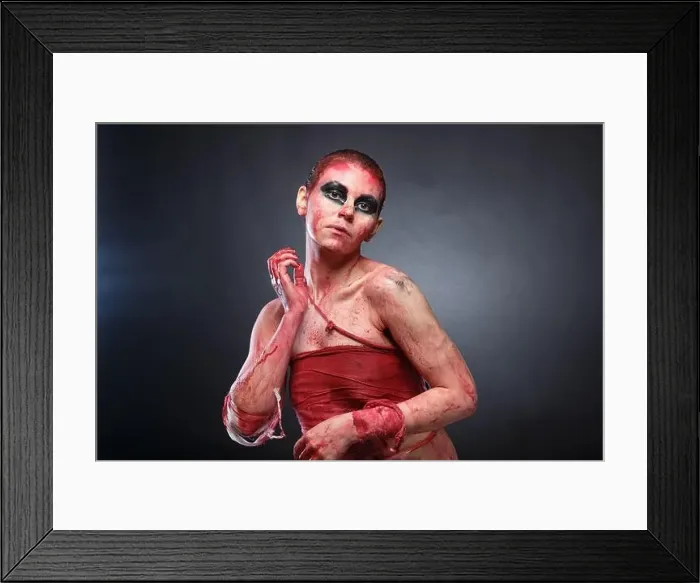 Framed Print : Photo of young girl in fake blood on grey background Framed Print : Photo of young girl in fake blood on grey background