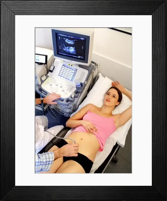 Framed Print : Woman undergoing pelvic ultrasound scan Framed Print : Woman undergoing pelvic ultrasound scan