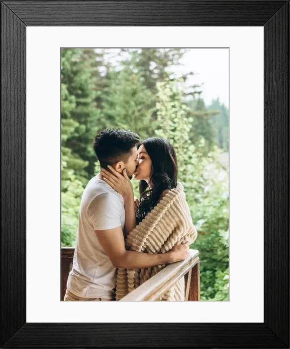 Framed Print : A man hugs and kisses a woman on the balcony. They have a honeymoon or close relationship and love Framed Print : A man hugs and kisses a woman on the balcony. They have a honeymoon or close relationship and love