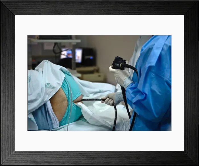 Framed Print : Doctor operating an endoscope to perform a colonoscopy examination procedure on a patient Framed Print : Doctor operating an endoscope to perform a colonoscopy examination procedure on a patient