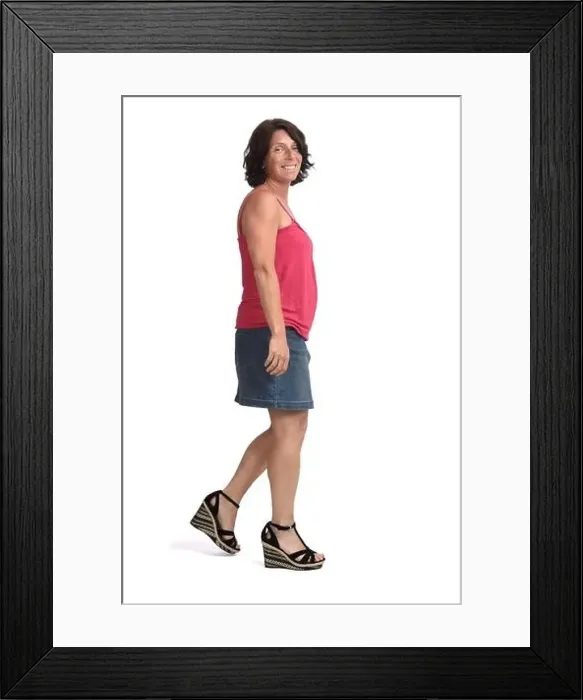Framed Print : side view of a woman walking with denim skirt on white background Framed Print : side view of a woman walking with denim skirt on white background