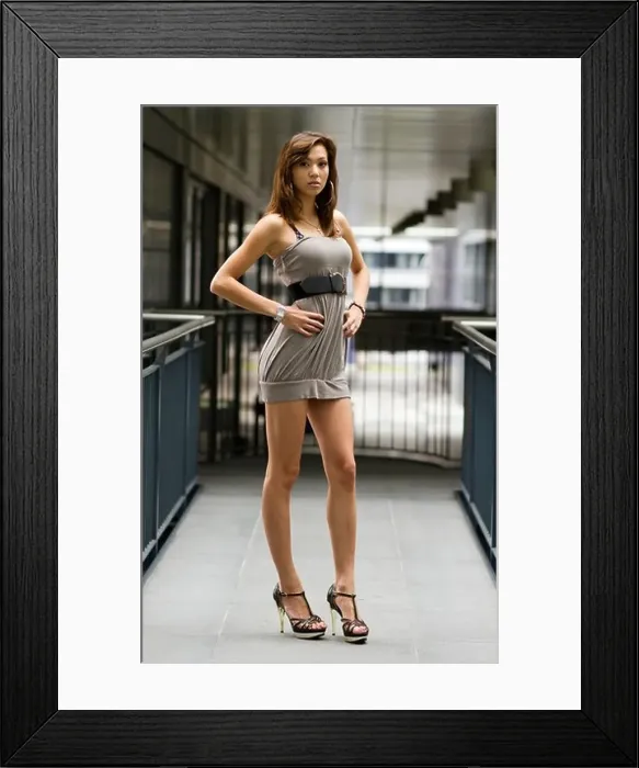 Framed Print : Young woman posing in a short gray dress and high heels Framed Print : Young woman posing in a short gray dress and high heels