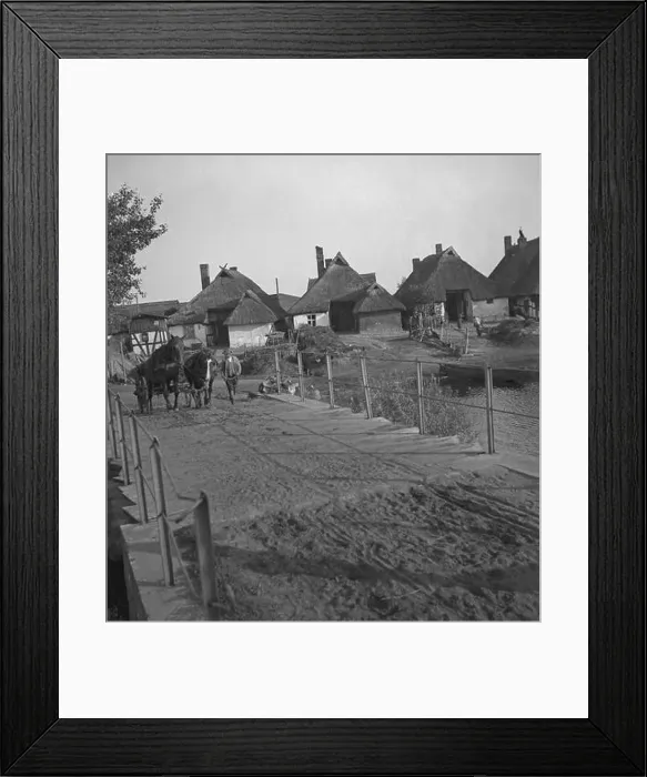 Framed Print : A farmer leads a horse-drawn carriage over a bridge at a village on the Baltic coast in Pomerania (Kamp or Deep) Framed Print : A farmer leads a horse-drawn carriage over a bridge at a village on the Baltic coast in Pomerania (Kamp or Deep)