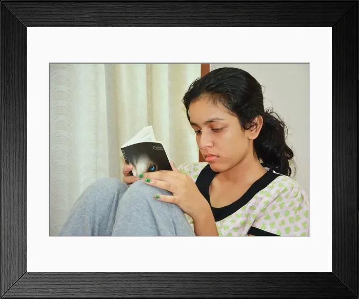 Framed Print : young girl reading book