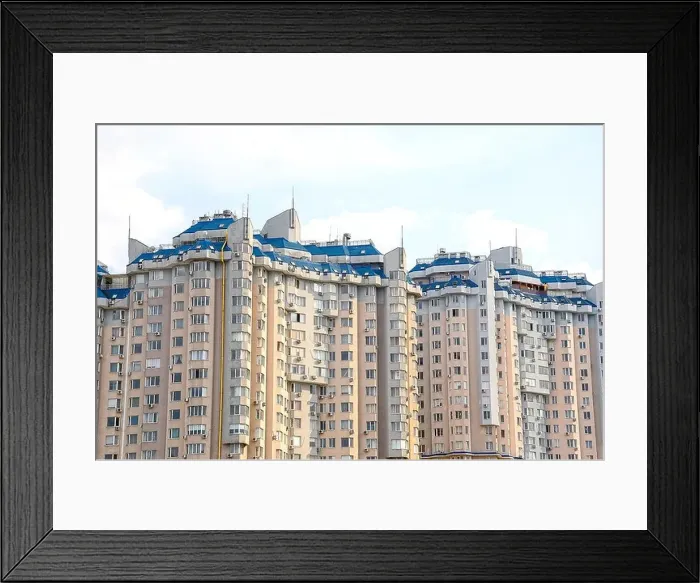 Framed Print : Multi-storey building construction on a background of blue sky Framed Print : Multi-storey building construction on a background of blue sky