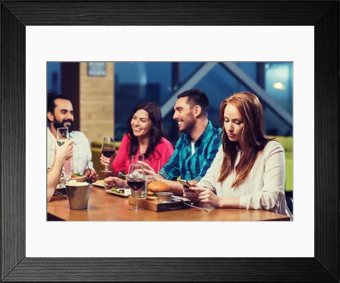 Framed Print : woman with smartphone and friends at restaurant Framed Print : woman with smartphone and friends at restaurant