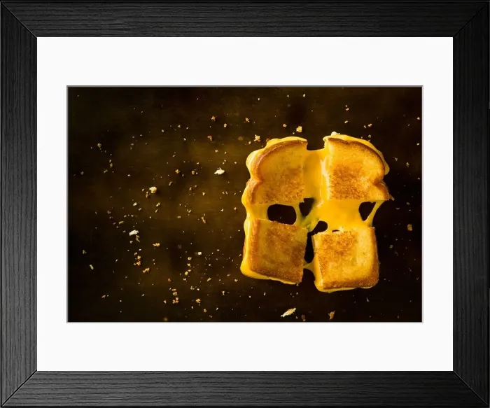 Framed Print : A Grilled Cheese Sandwich cut in four squares pulling the cheese on a wood table Framed Print : A Grilled Cheese Sandwich cut in four squares pulling the cheese on a wood table