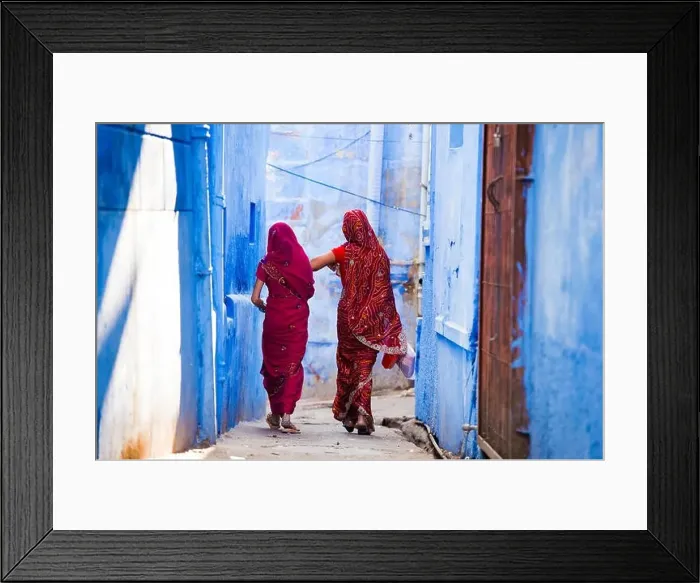 Framed Print : Two women dressed in the traditional Indian Saree are walking through the narrow streets of the blue city of Jodhpur Framed Print : Two women dressed in the traditional Indian Saree are walking through the narrow streets of the blue city of Jodhpur