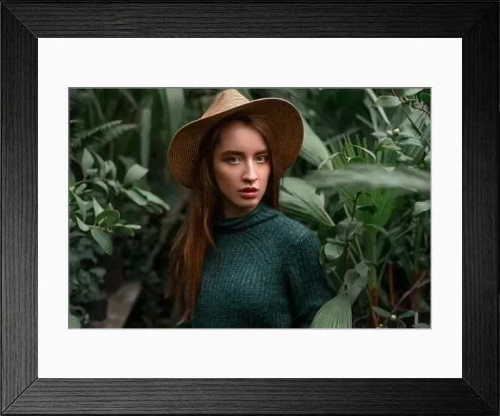 Framed Print : Woman standing at nursery in a greenhouse