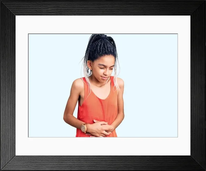 Framed Print : Cute african american girl wearing casual clothes with hand on stomach because indigestion Framed Print : Cute african american girl wearing casual clothes with hand on stomach because indigestion
