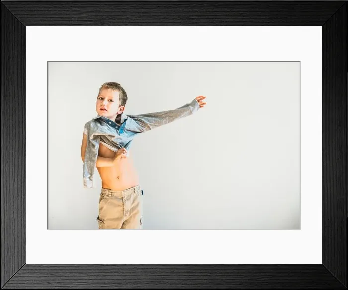 Framed Print : Child undressing before going to sleep, alone, learning to be independent Framed Print : Child undressing before going to sleep, alone, learning to be independent